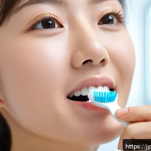 잇몸질환 예방을 위한 칫솔질 방법 - A close-up image of a Japanese woman gently brushing her teeth with a soft-bristled toothbrush, hold...