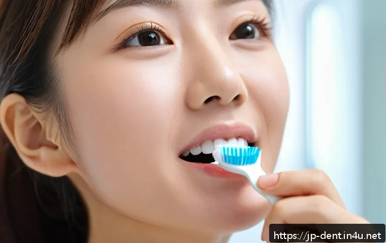잇몸질환 예방을 위한 칫솔질 방법 - A close-up image of a Japanese woman gently brushing her teeth with a soft-bristled toothbrush, hold...